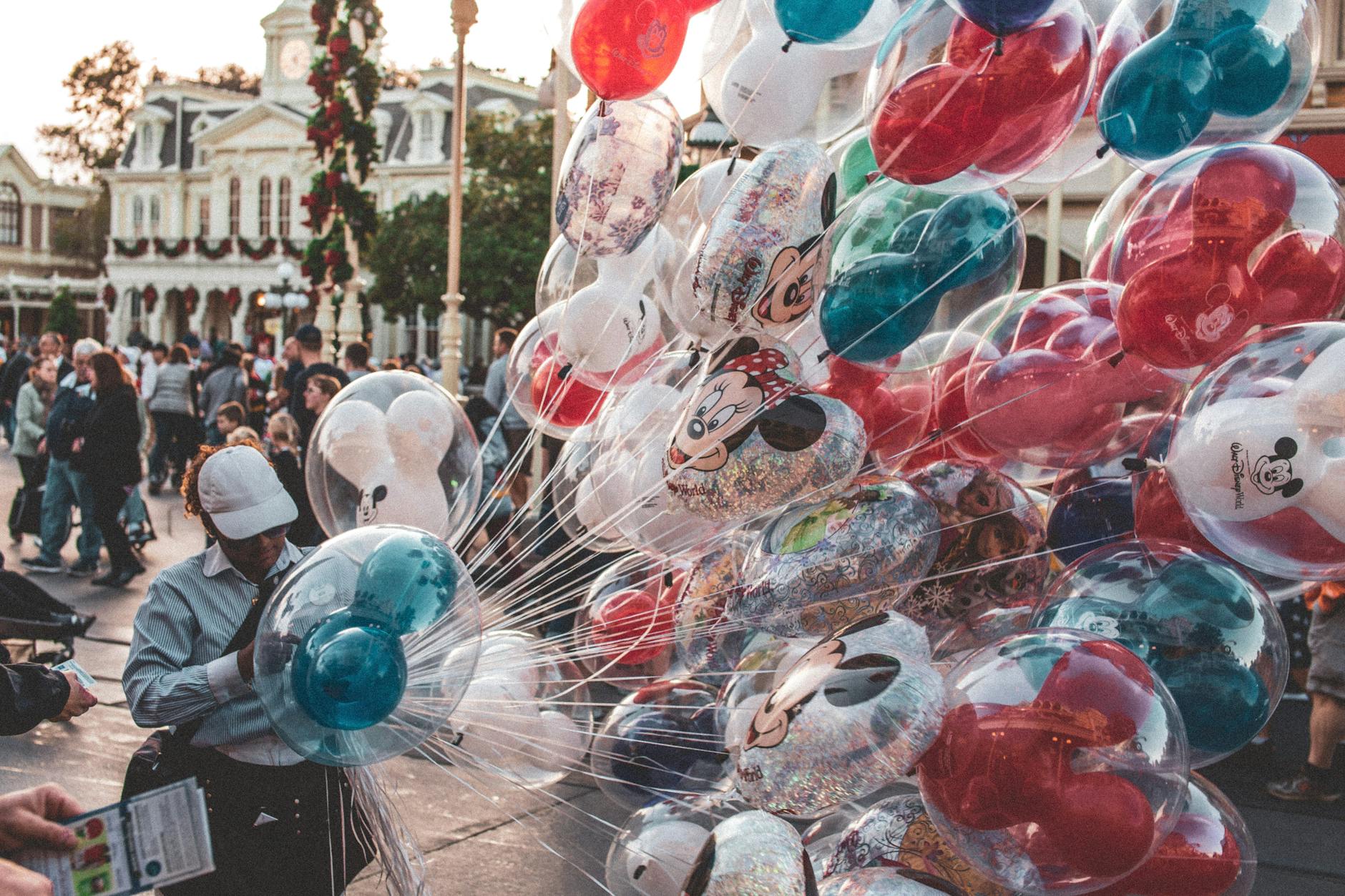 Colorful Disney character balloons on a theme park street