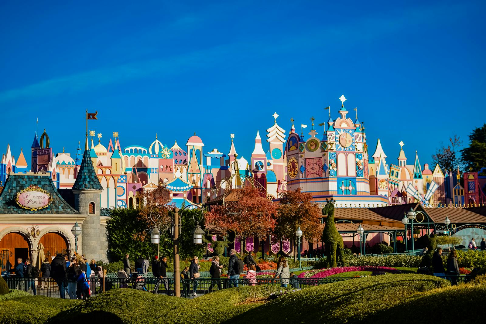 Disneyland Paris colorful themed architecture with guests walking through the park