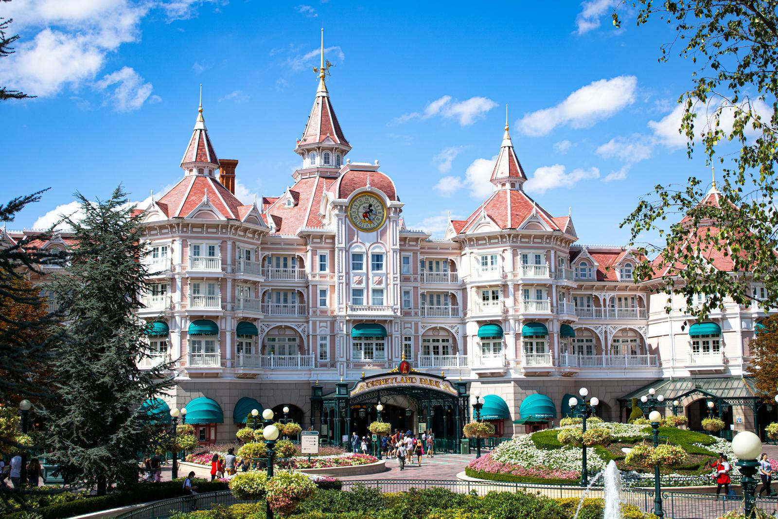 Disneyland Paris hotel entrance under a bright blue sky with resort architecture