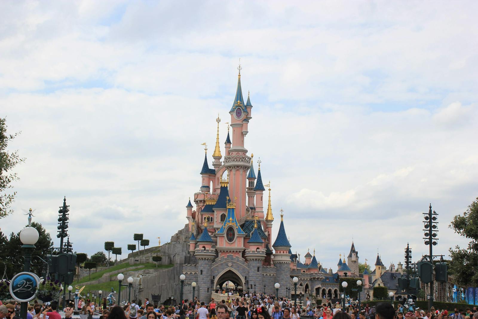 Sleeping Beauty Castle at Disneyland Paris with guests exploring the park