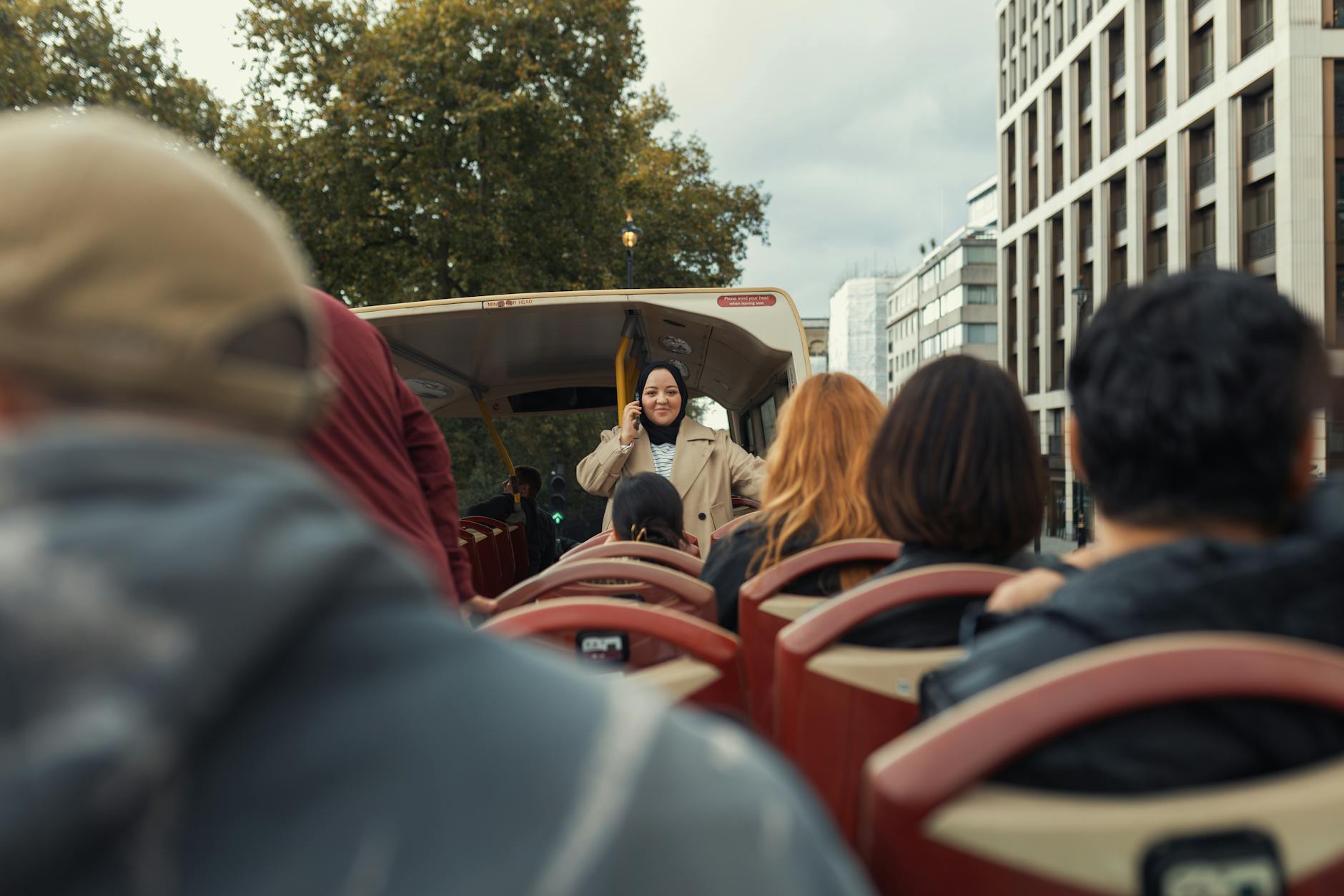 A diverse group of people on an open-top bus city tour