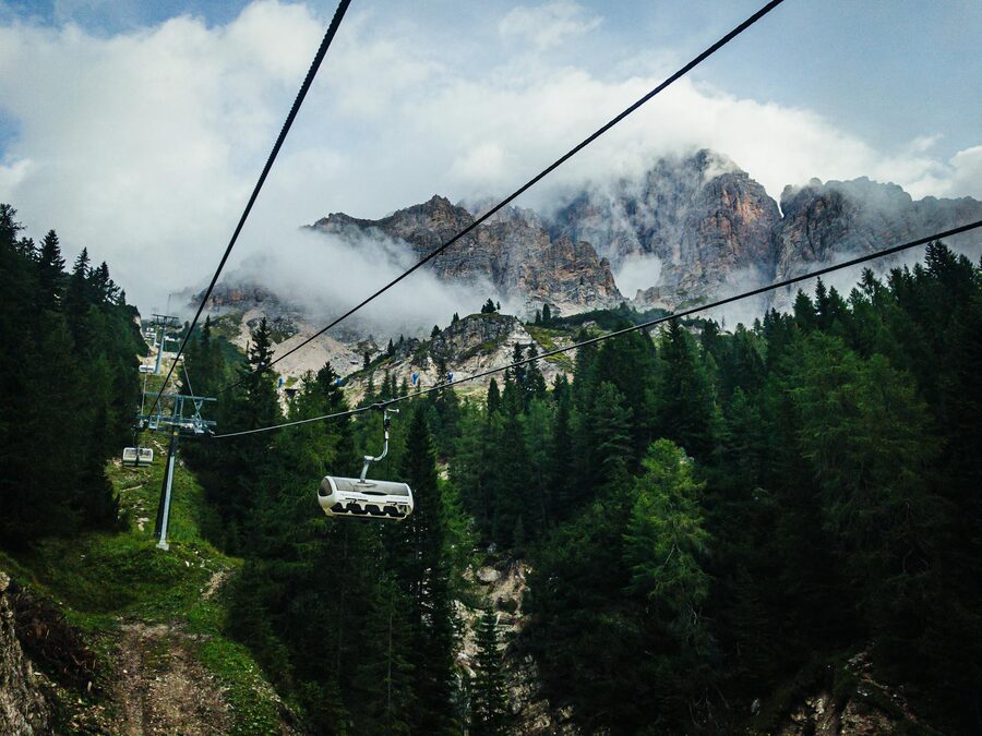 Cable car over Dolomites forest in summer