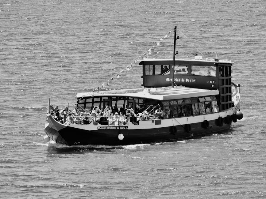 Tourist boat cruising on the Douro River between terraced hillsides