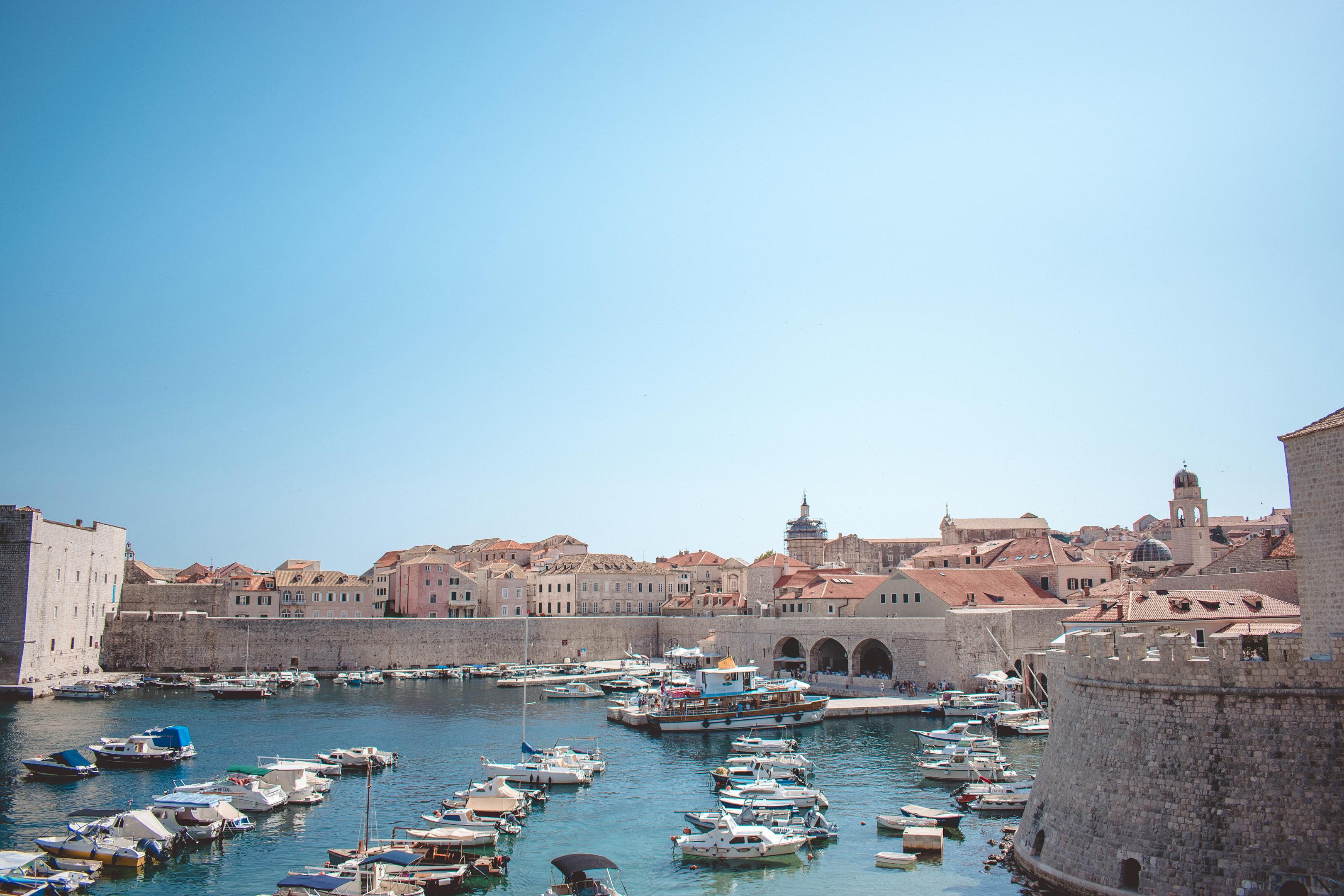Charming view of the historic harbor in Dubrovnik with boats and medieval architecture