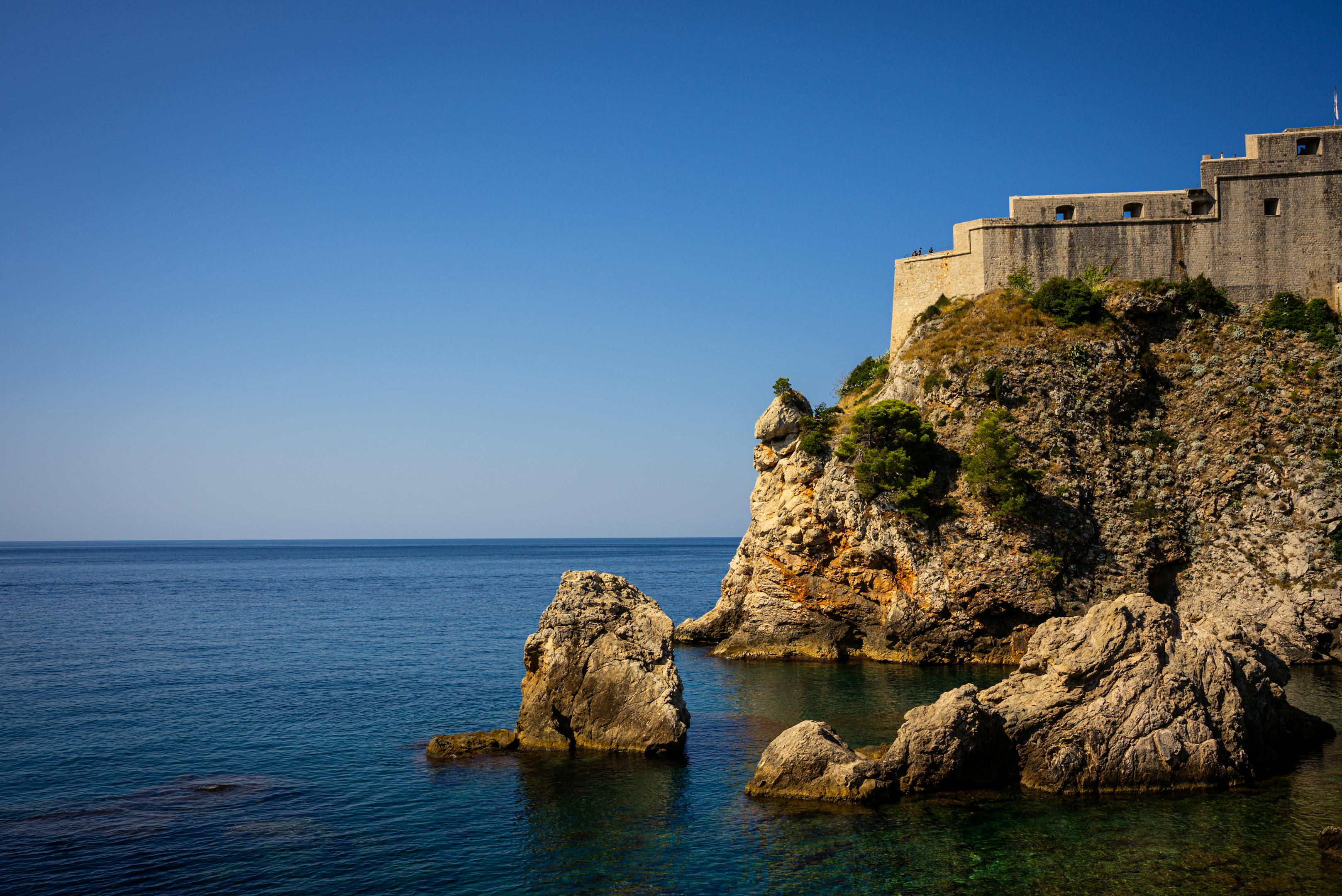 Scenic view of Fort Lovrijenac against a bright blue sky along the Adriatic Sea in Dubrovnik, Croatia