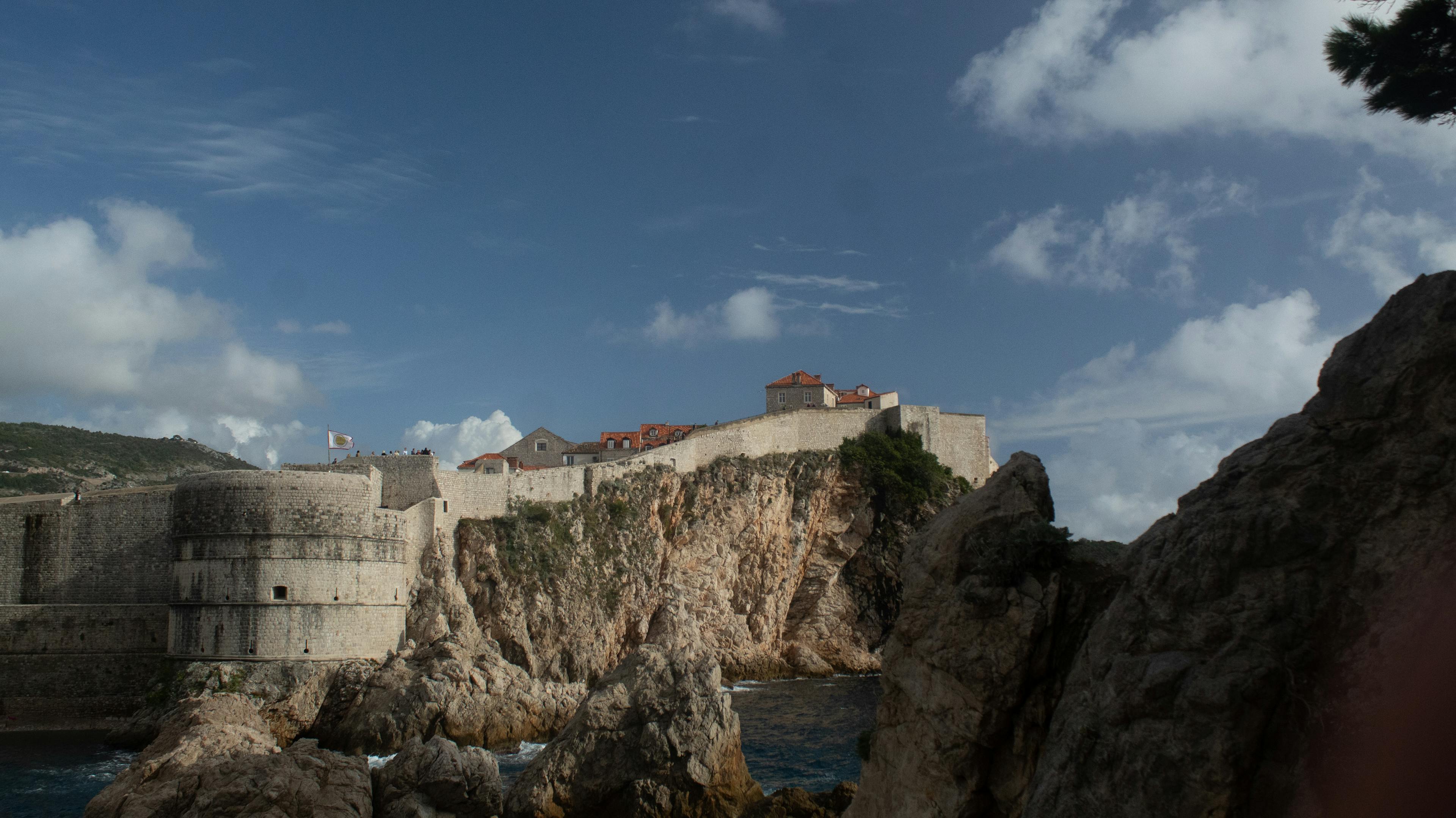 Explore the stunning medieval fortress in Dubrovnik, Croatia, set against the rugged coastal cliffs and blue skies