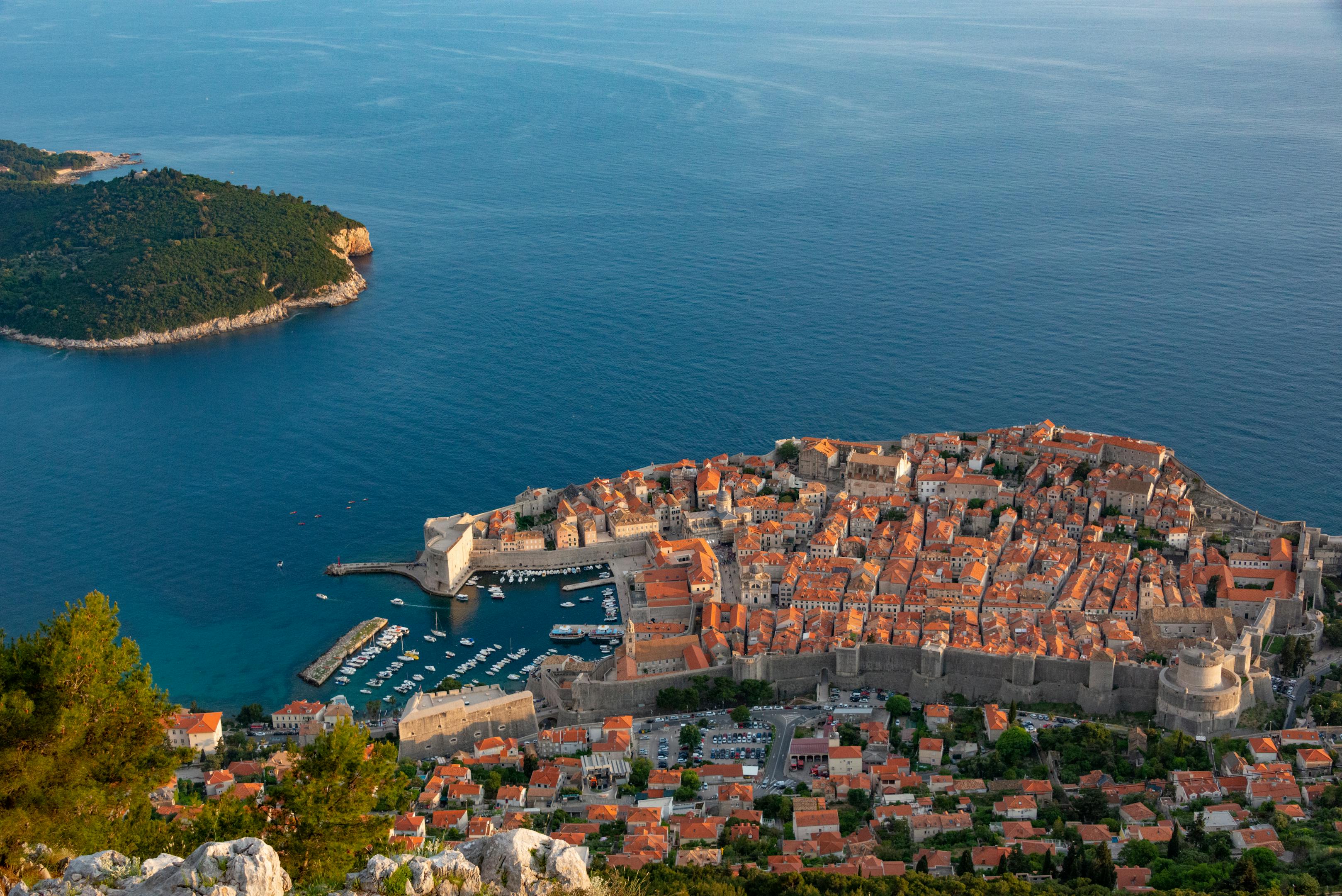 Stunning aerial view of Dubrovnik's old town and harbor, showcasing medieval architecture and Adriatic Sea