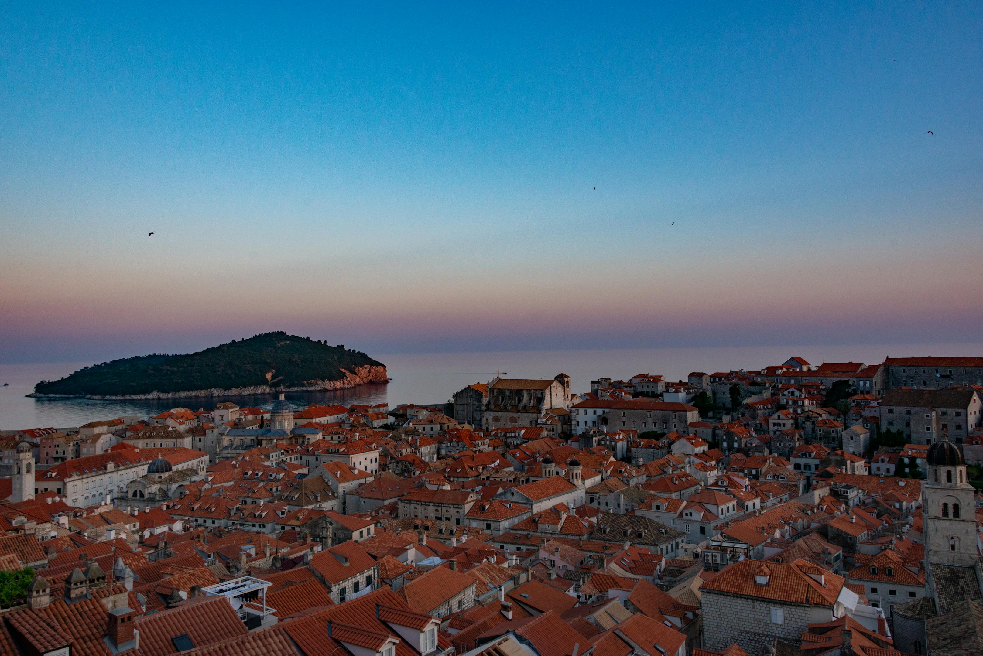 Stunning view of Dubrovnik's terracotta rooftops and Lokrum Island at sunset