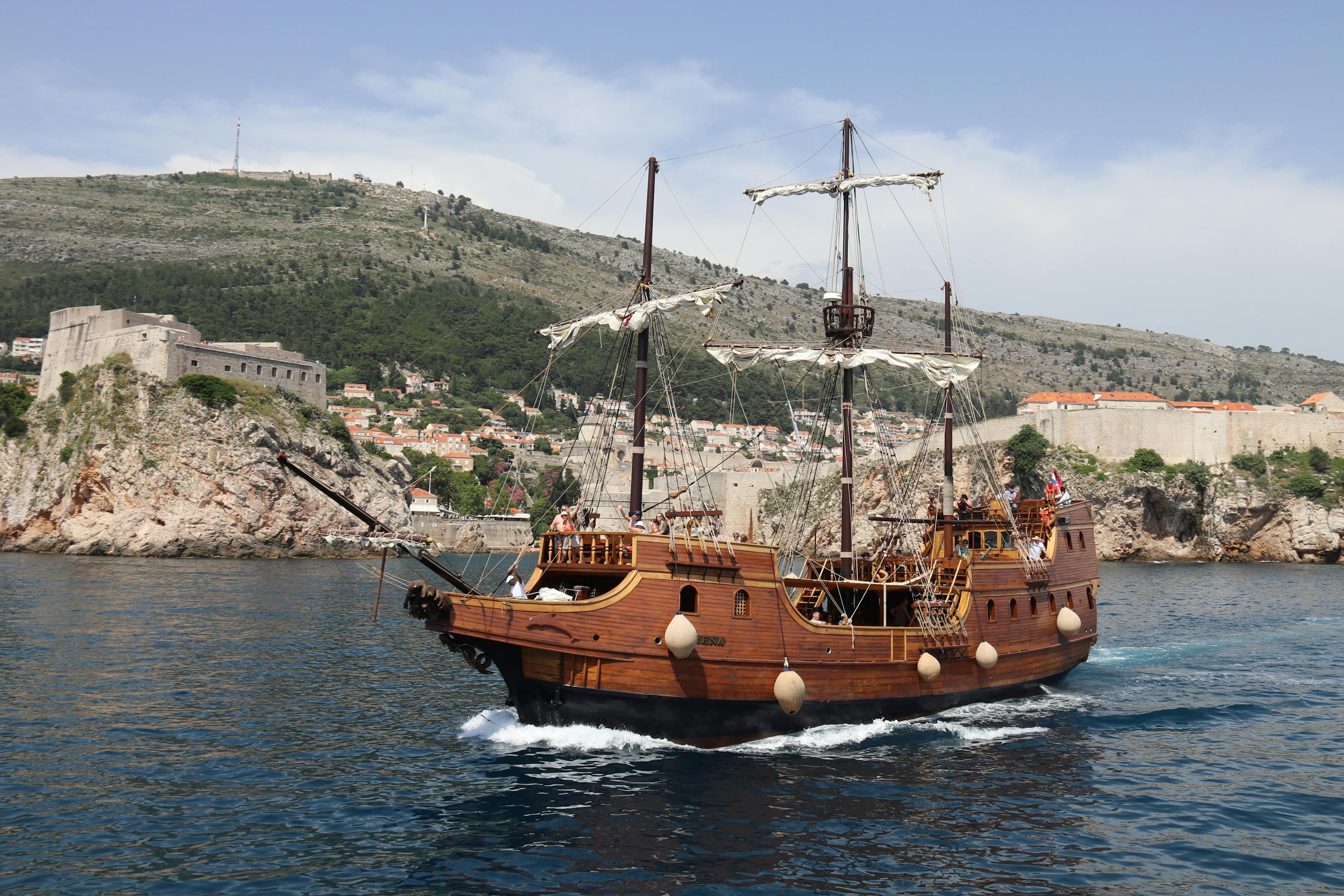 A vintage sailing ship cruises along Dubrovnik's scenic Adriatic coast in summer