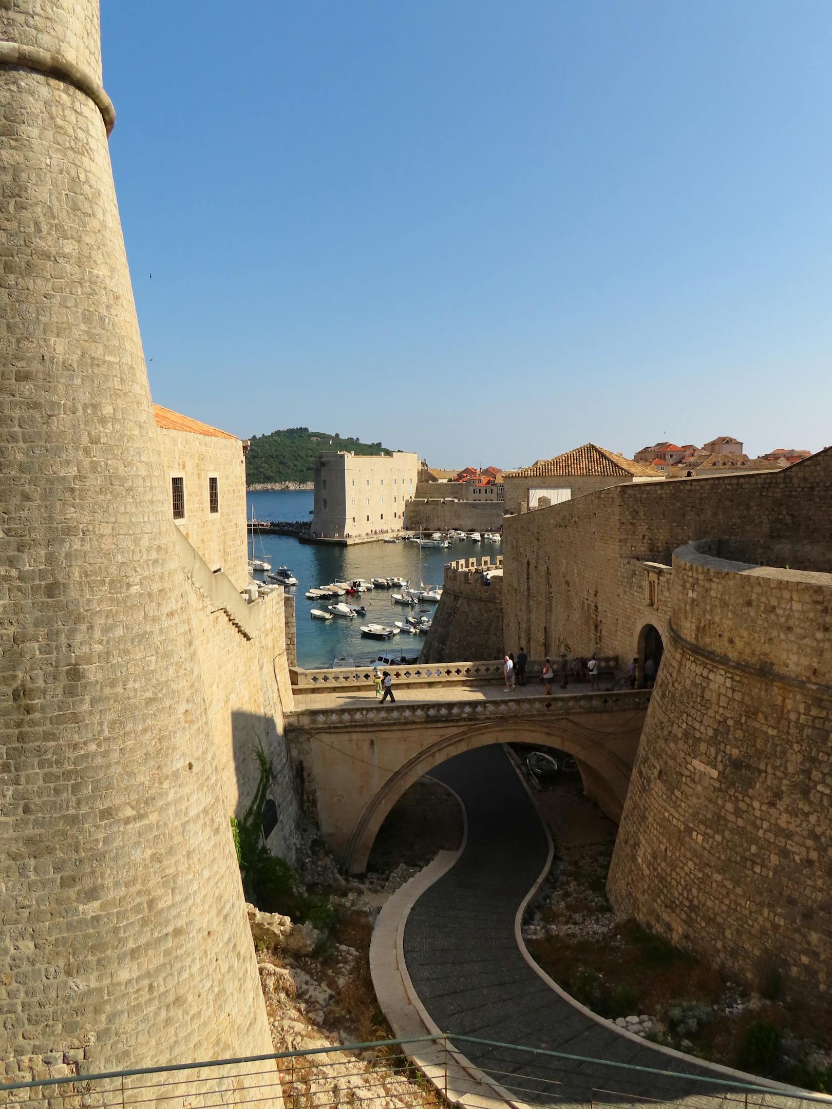 Historic walls of Dubrovnik with a view of the marina and iconic stone architecture