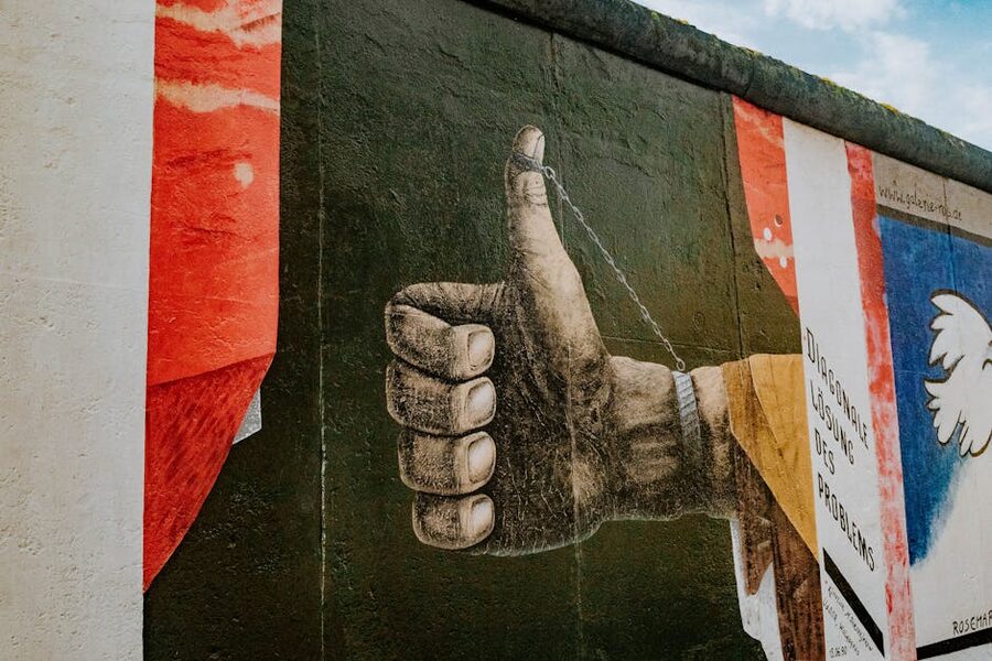 Thumbs up street art mural at East Side Gallery Berlin