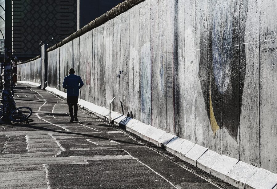 Runner jogging past Berlin Wall monument
