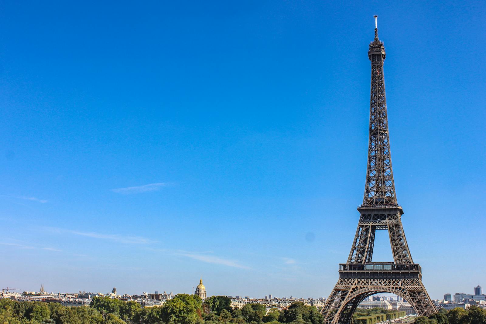 The Eiffel Tower on a bright daytime with a clear blue sky behind