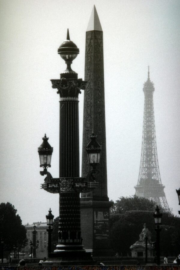 Eiffel Tower framed by monuments on a foggy Paris day