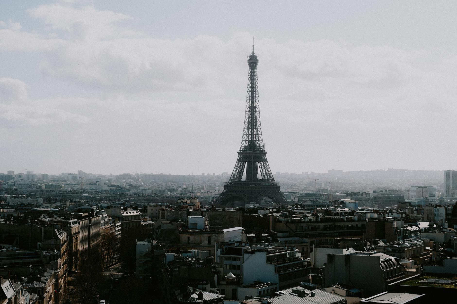 Eiffel Tower rising above the Paris skyline on an overcast cloudy day