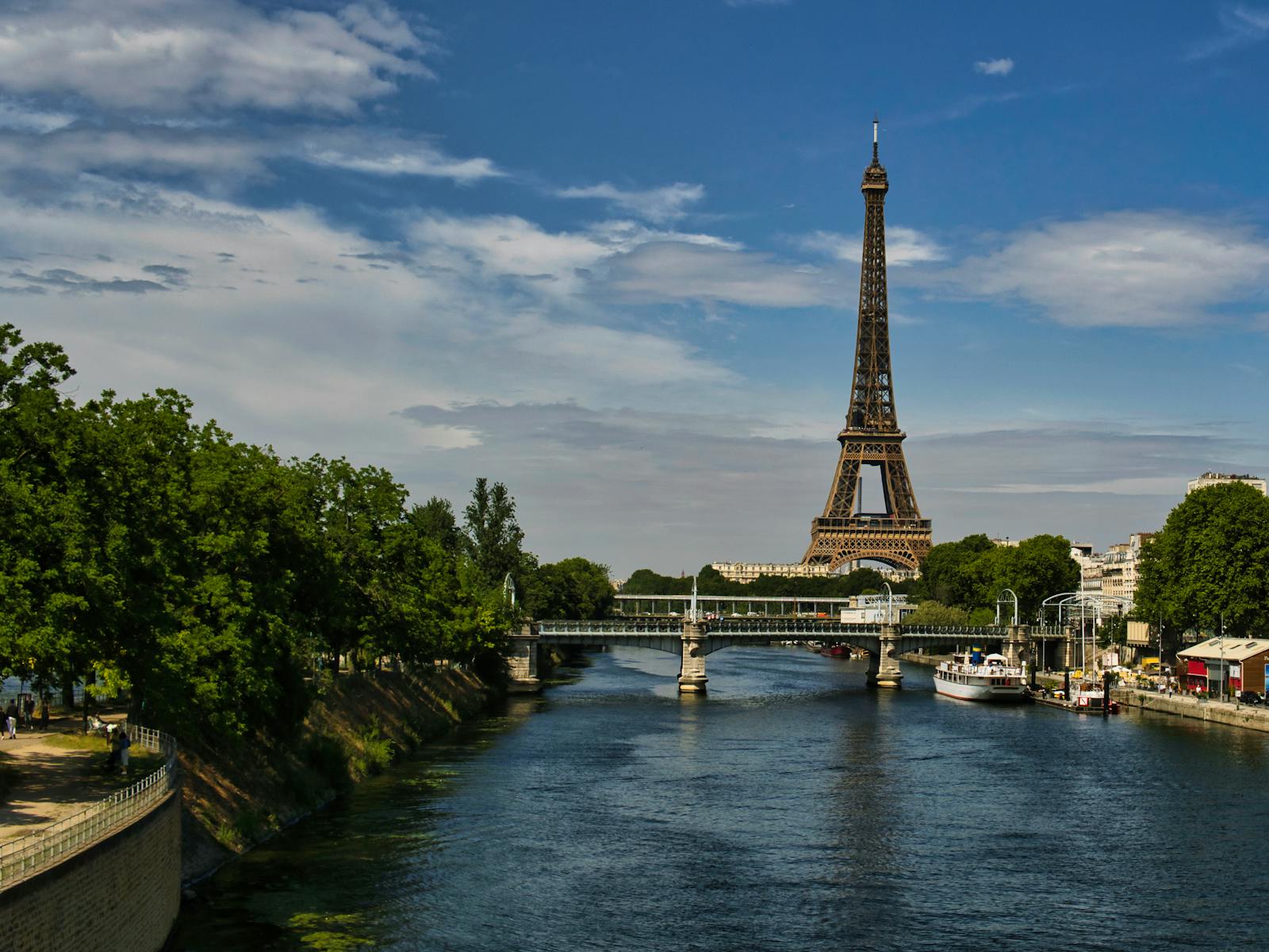 The Eiffel Tower with the Seine River and Paris skyline on a sunny day