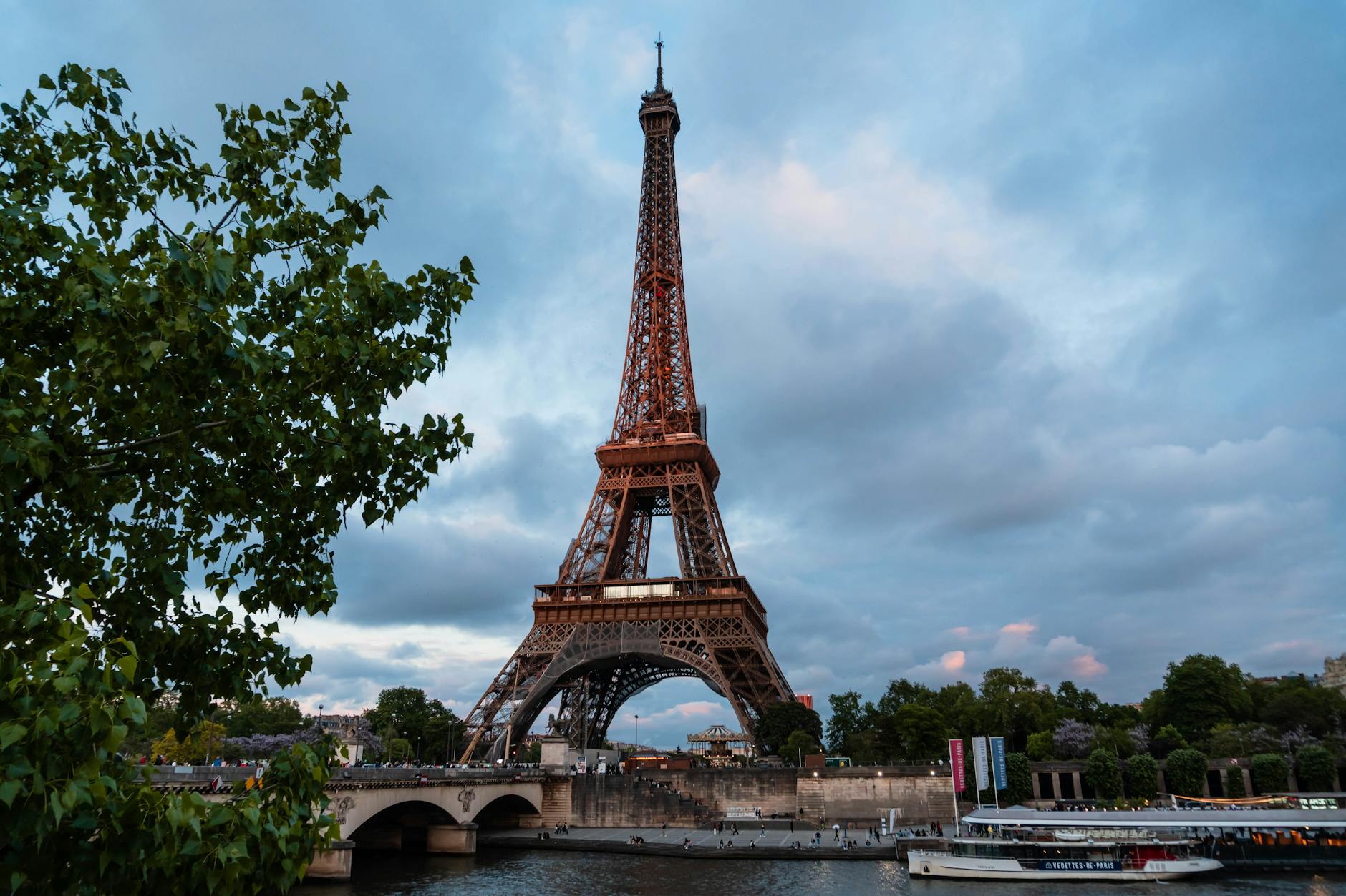 Eiffel Tower reflected in the Seine at sunset with golden light on the water