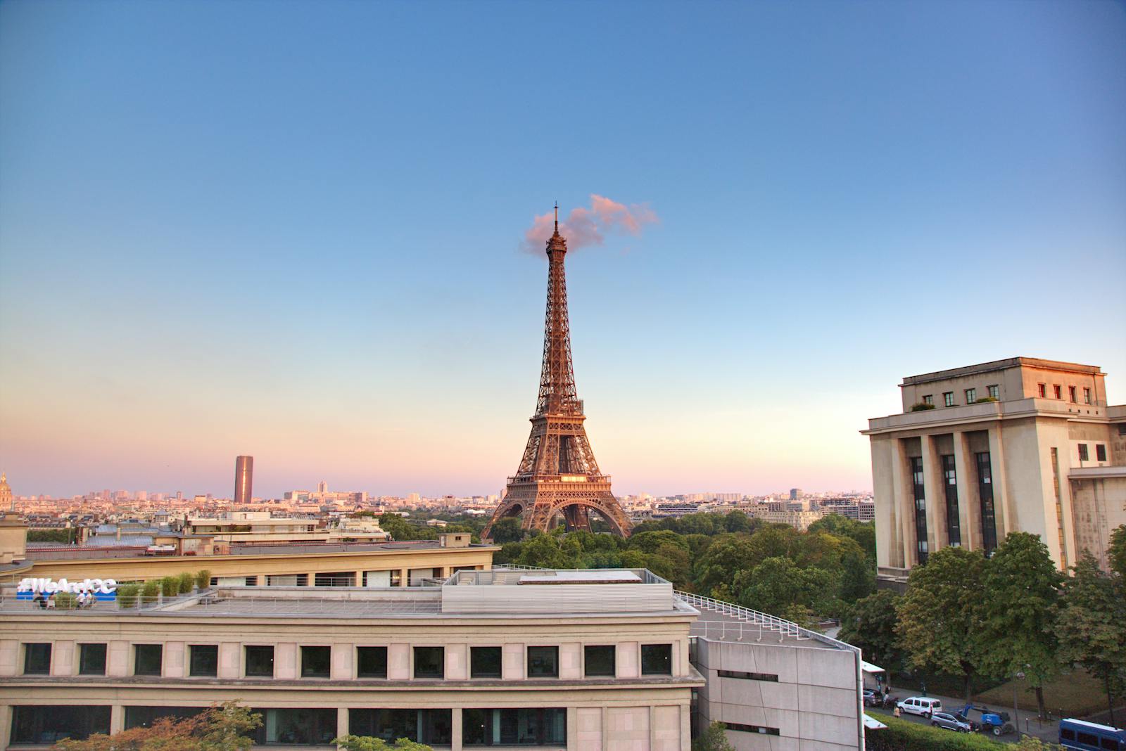 The iconic Eiffel Tower at sunrise showing warm morning light across Paris