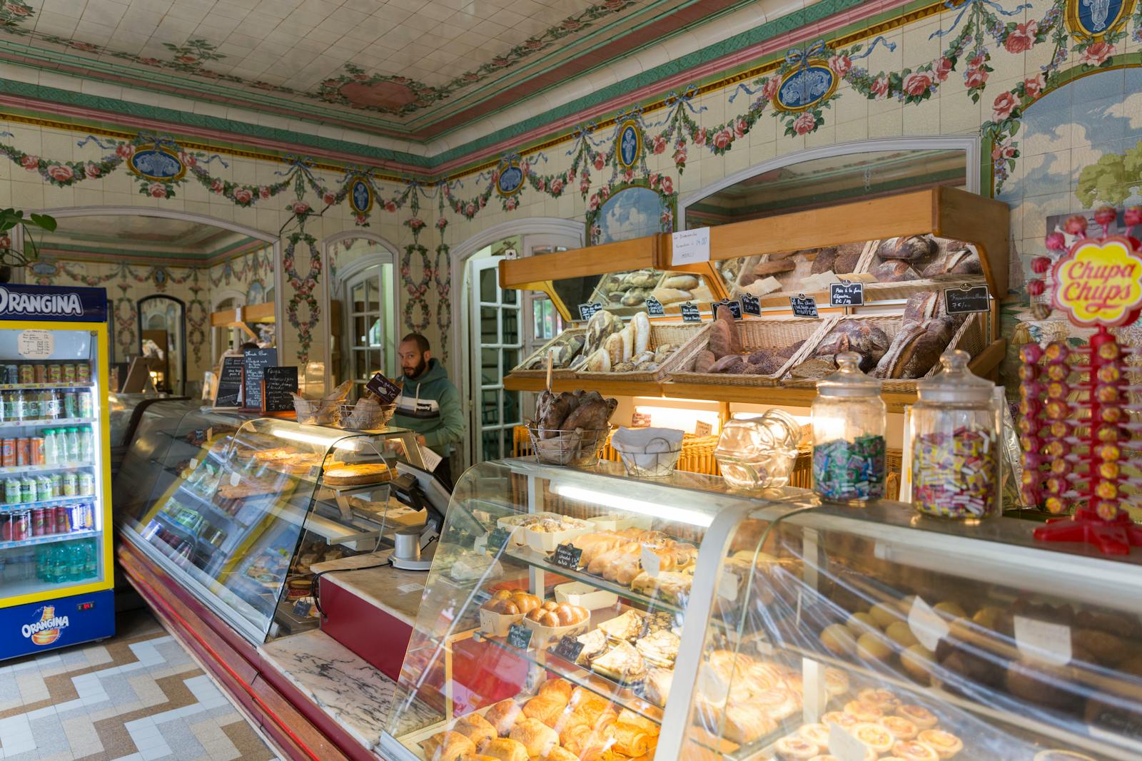 Parisian bakery display with breads and pastries seen through the window