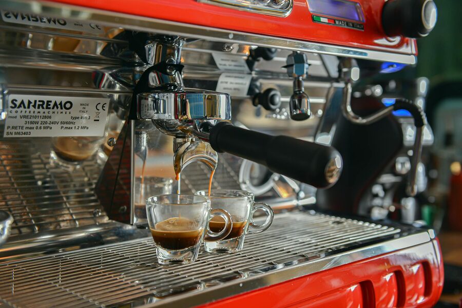 Espresso being poured into cups from machine