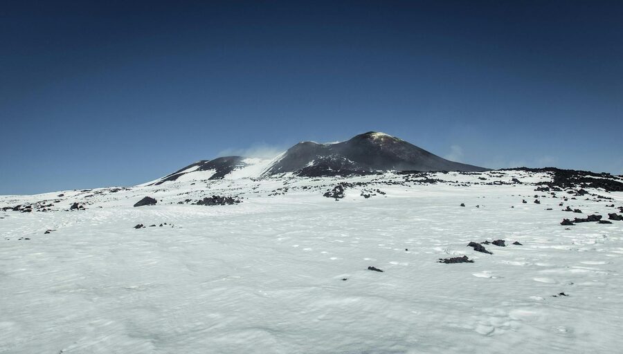 Mount Etna snow-covered under clear sky
