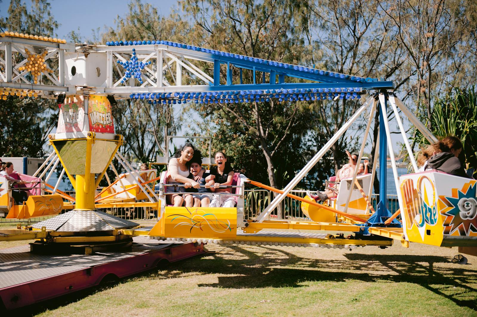 Families on an outdoor amusement park ride on a sunny day at Disneyland Paris