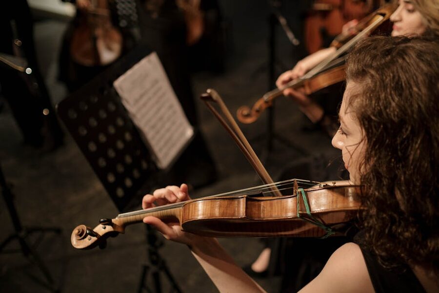 Female violinist performing in orchestra