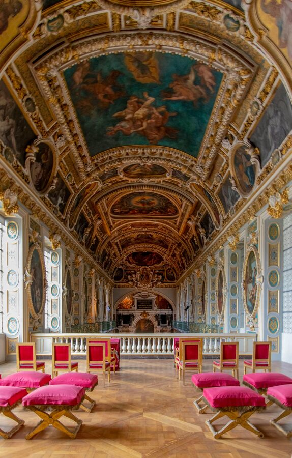 Luxurious hall interior in Fontainebleau Palace with decorative ceiling