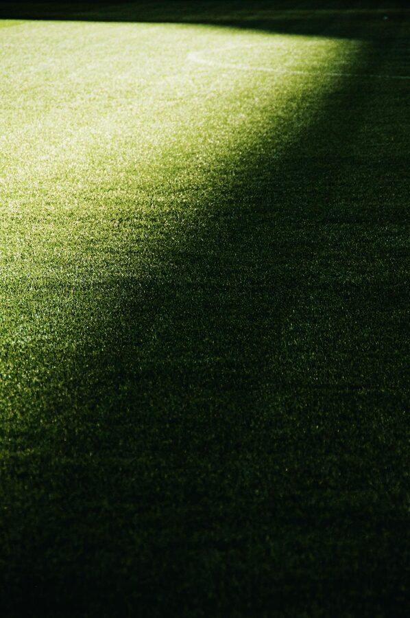 Green football pitch inside a stadium