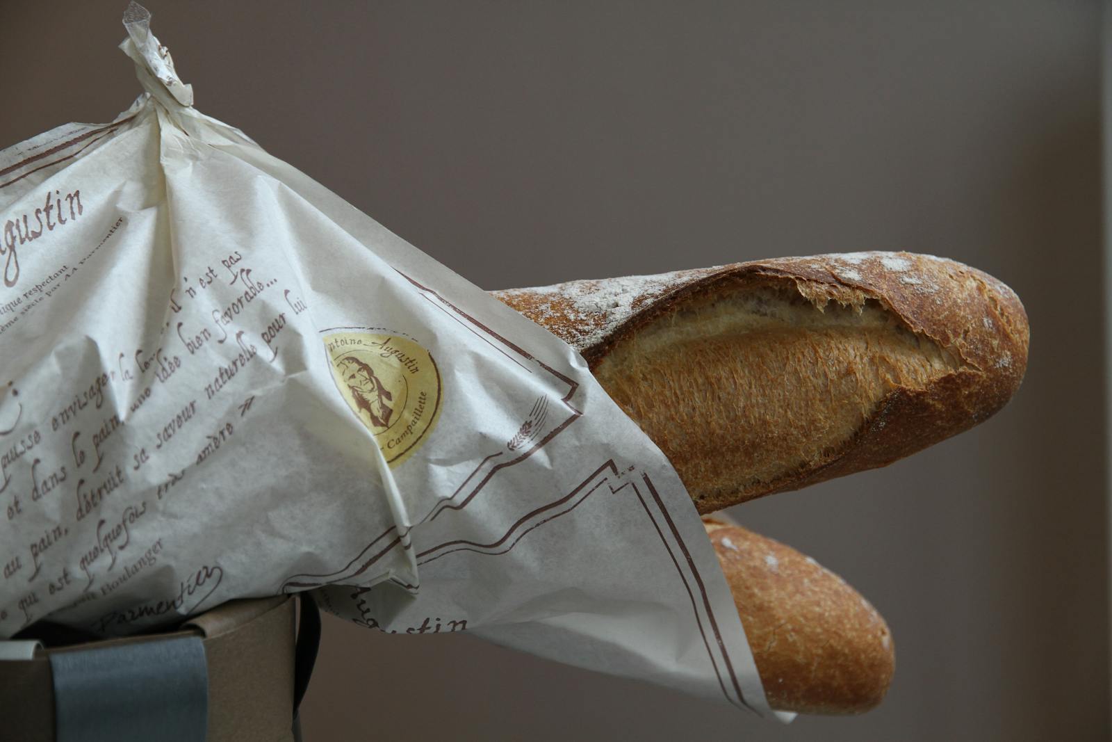 Crisp French baguette wrapped in paper from a neighborhood Paris bakery
