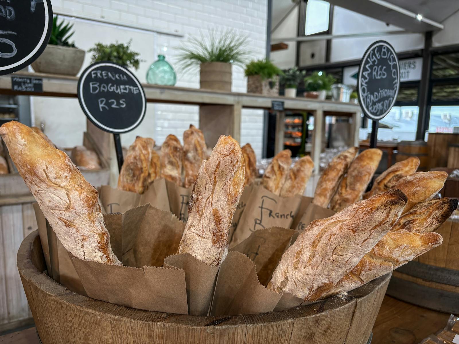 Freshly baked French baguettes lined up in a traditional Paris bakery