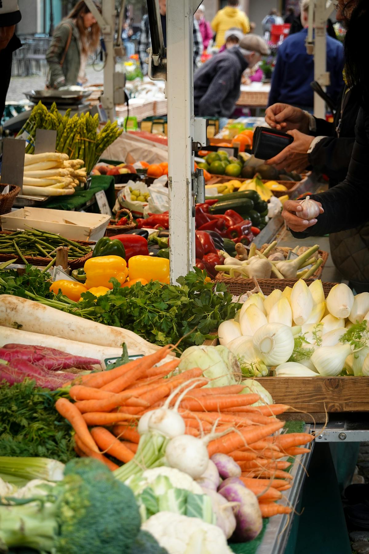 Colourful fresh produce at a bustling outdoor farmers market