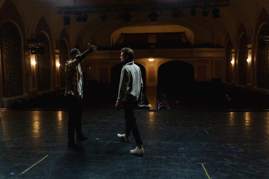 Actors practicing scene in empty theater