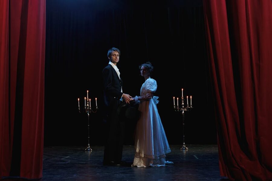 Dramatic theater scene with elegant performers