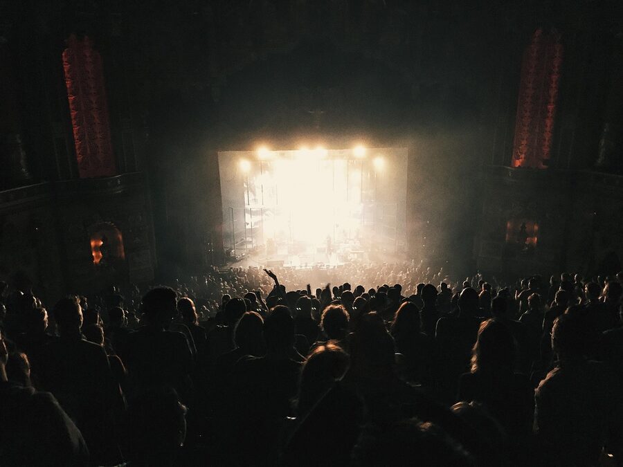 Concert audience in backlit stage lighting