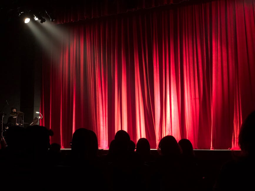 Theater stage red curtains audience silhouette