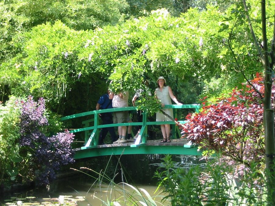 Wisteria-draped Japanese footbridge over the water lily pond in Claude Monets garden at Giverny