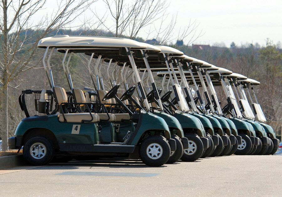 Multiple golf carts parked in a row