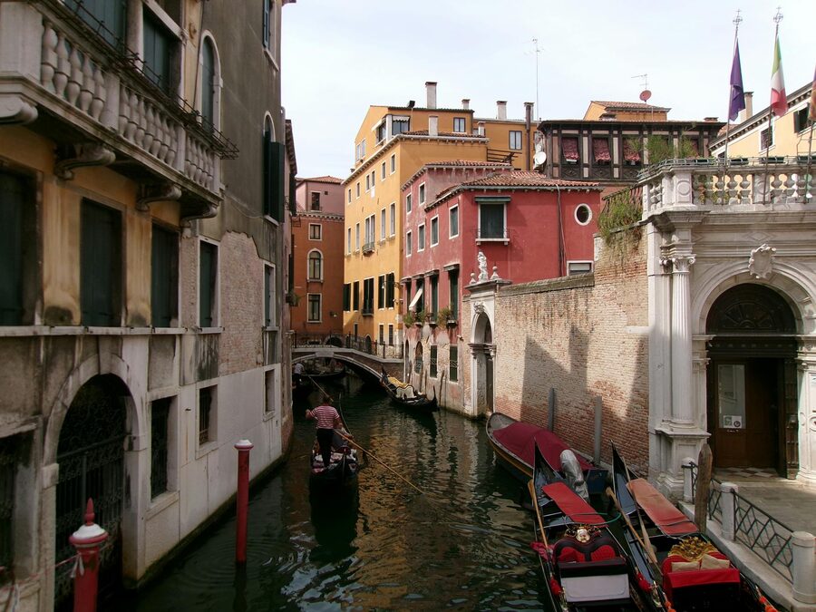Gondola navigating a canal with colorful Venetian buildings