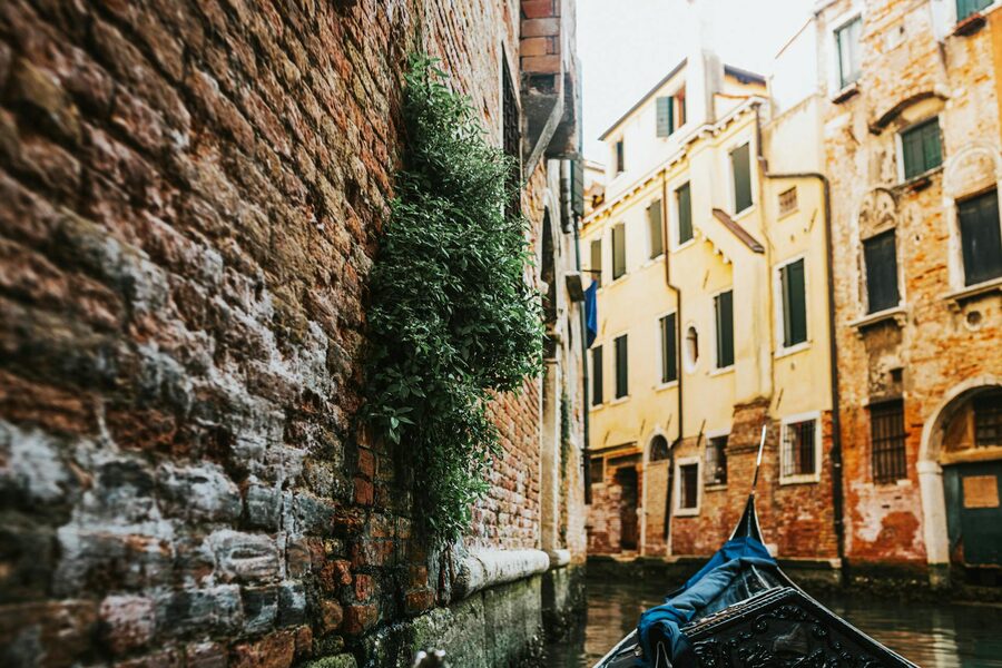 Gondola on a Venetian canal with brick buildings