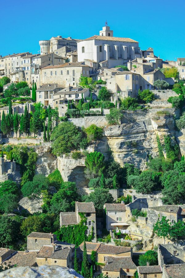 Village of Gordes perched on a cliff in Provence under clear blue sky