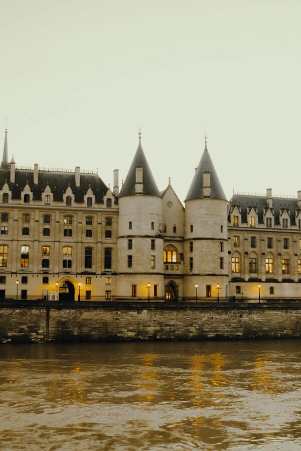 Gothic castle illuminated at twilight by the river
