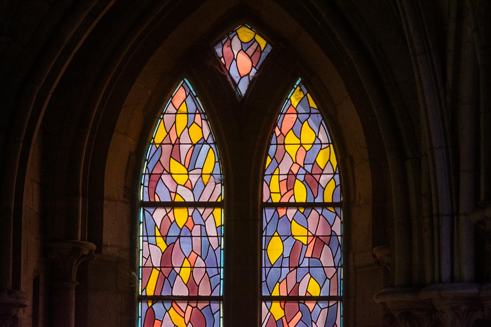 Gothic cathedral interior with colorful stained-glass window designs