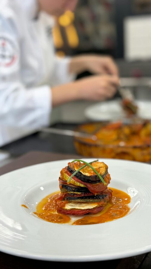 Gourmet ratatouille plated in a professional kitchen