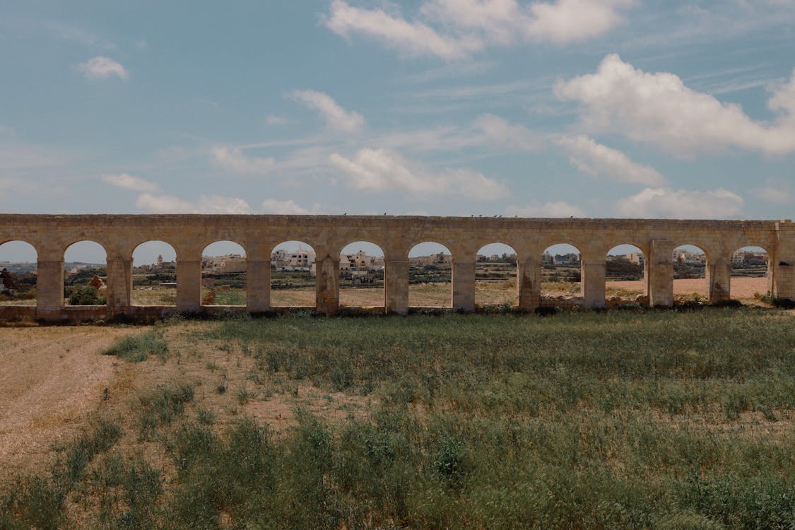 Gozo aqueduct and green fields landscape