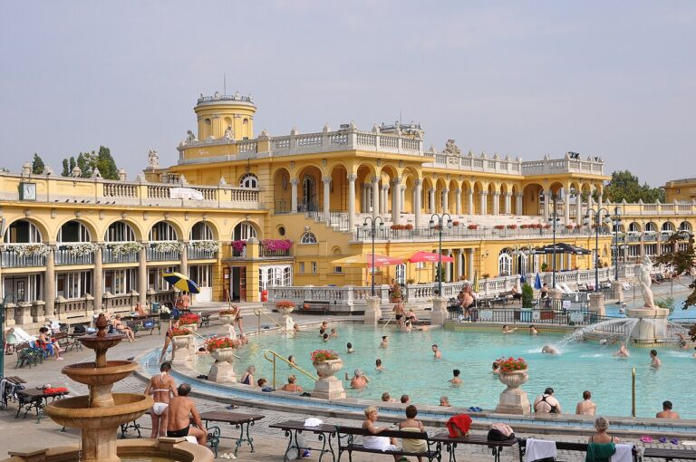 The outdoor pools at Széchenyi Thermal Bath in Budapest with yellow neo-baroque building in background