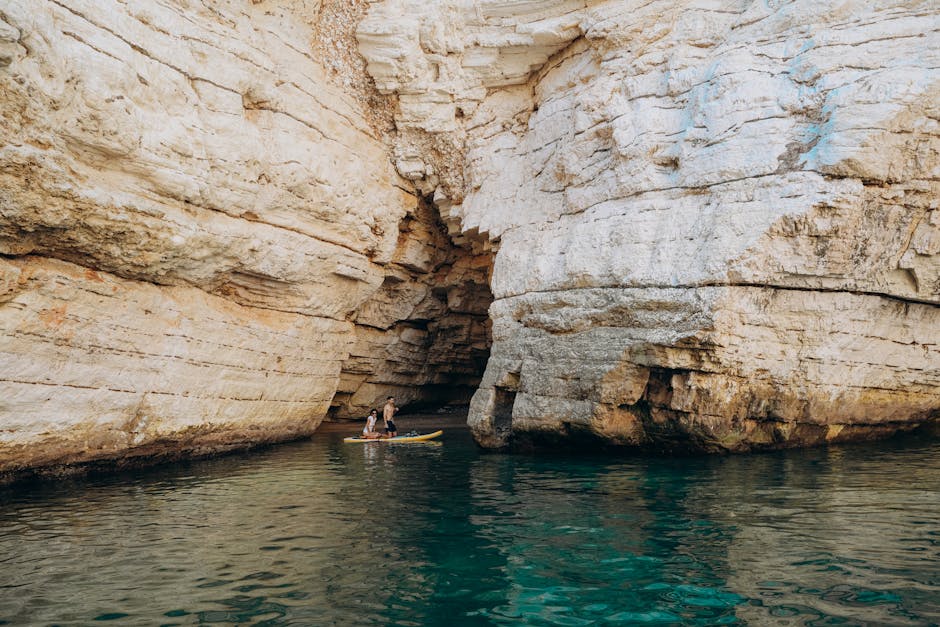 Kayak approaching the entrance of a sea cave on the coast