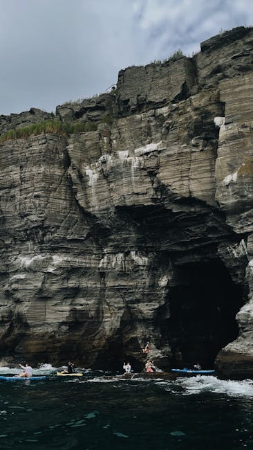 Kayaker exploring a rocky sea cave