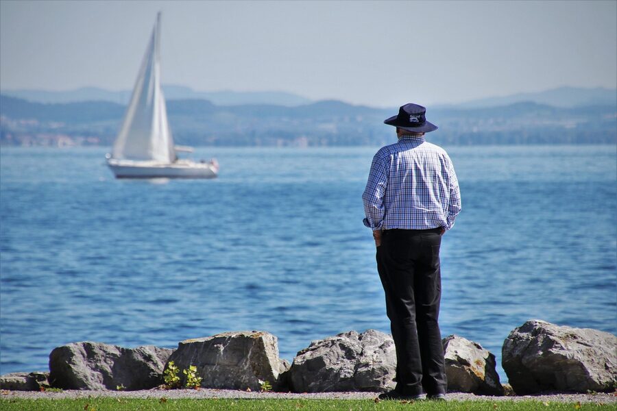 Konstanz harbor with sailboat and elderly man