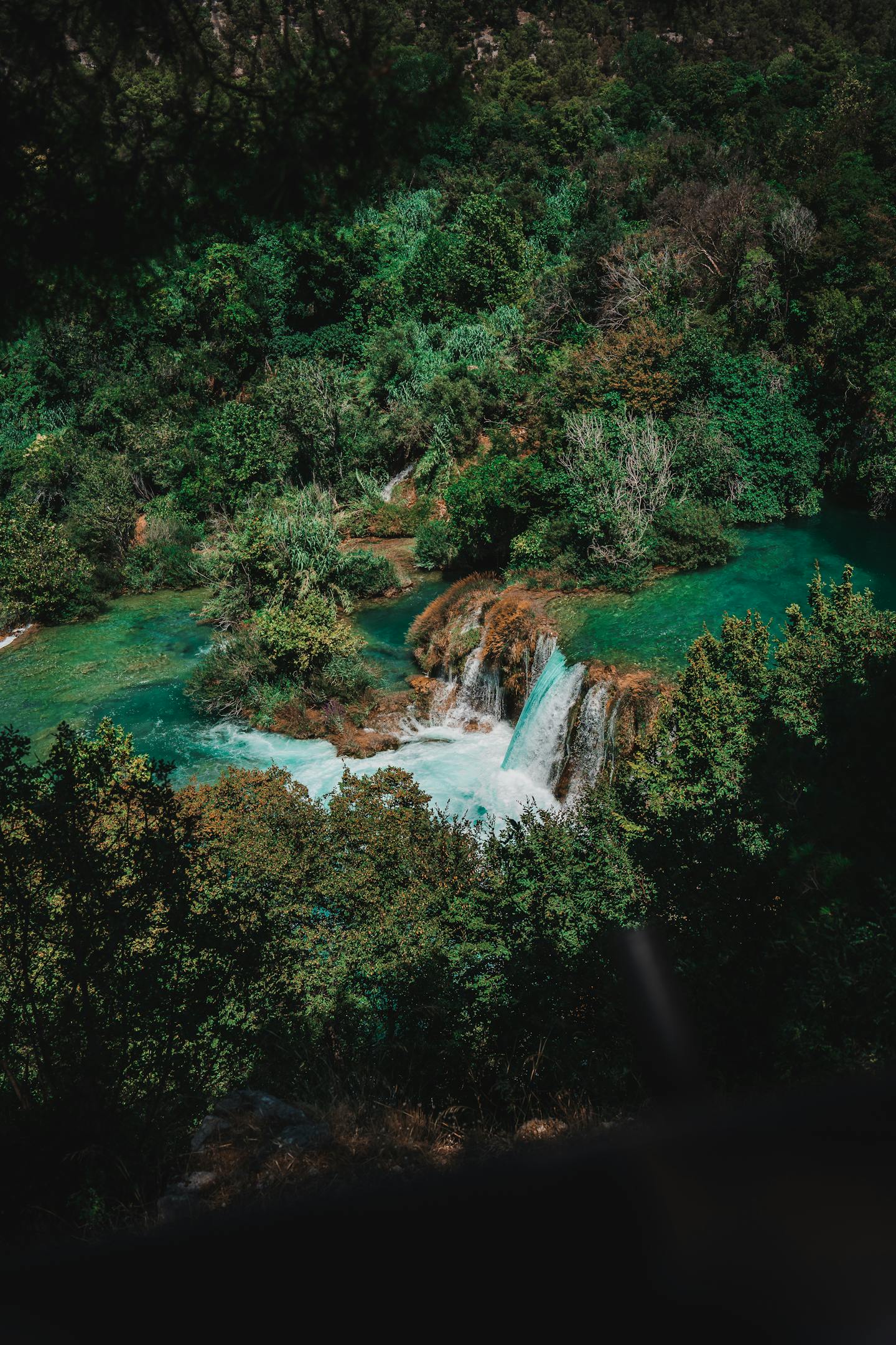Beautiful cascading waterfalls in Krka National Park surrounded by lush greenery